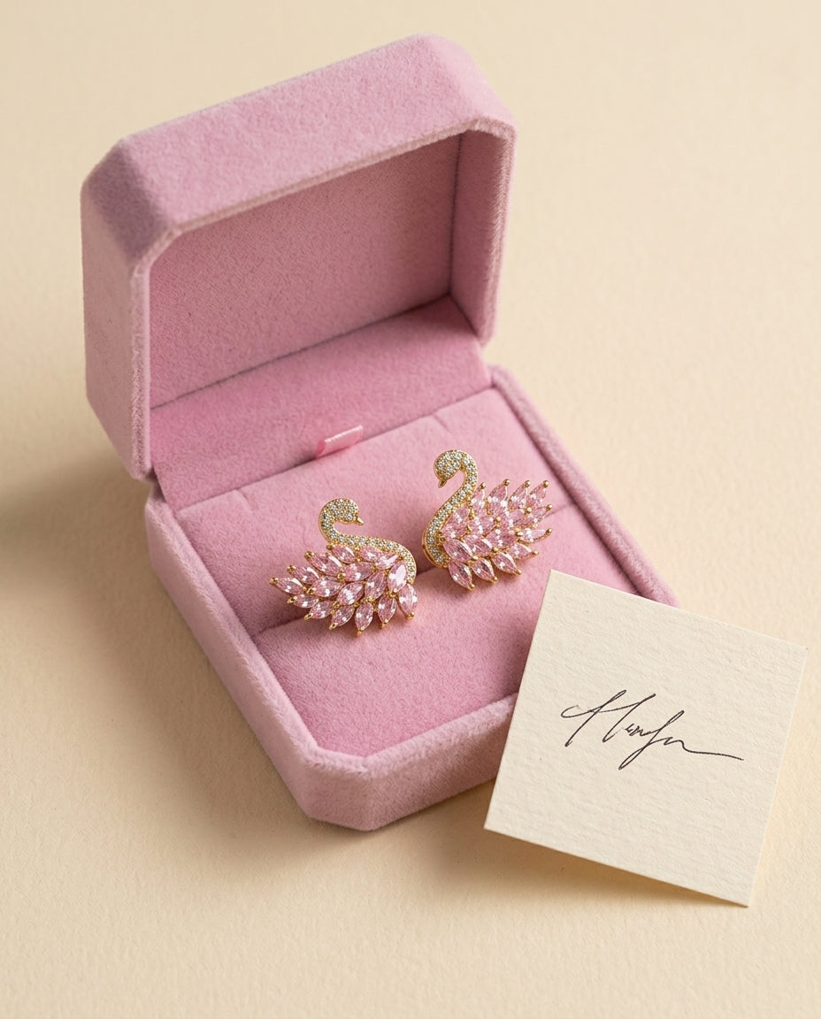 swan earrings in a pink gift box with a note