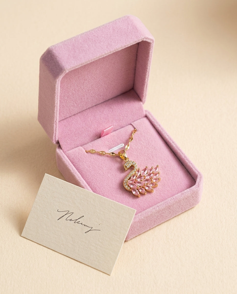 swan necklace in a pink gift box with a note